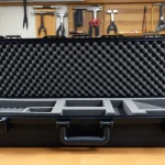 Custom foam for rifle case showcasing precision cuts and textures in a workshop.